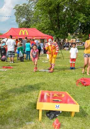 Ronald McDonald competes with the kids in one of the favorite games. Like every year, the local Hispanic Owner/ Operators of McDonald s participated in the Puerto Rican festivities.