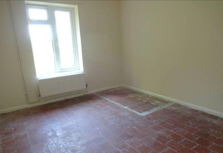 Bedroom - A double bedroom with quarry tiled floor, radiator, rear window and enclosed cupboard.