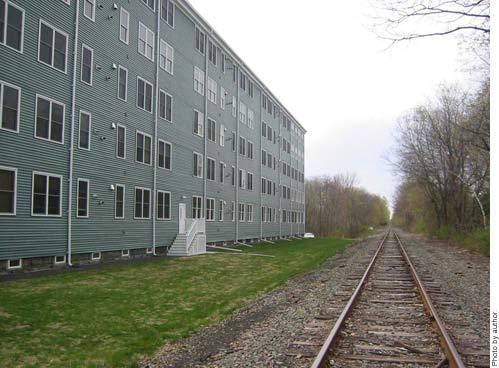 The proximity to the Boston and Maine Railroad line played a key role in the building?
