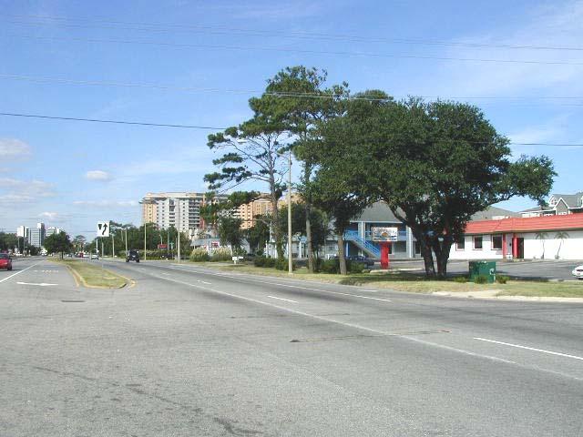 Road intersection, where the land use changes from predominantly residential to predominantly commercial uses.