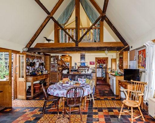To the right of the dining room is the kitchen offering a range of wall and floor built in units, quarry tiles, an Aga and a central island.