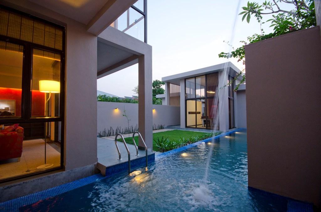 The rejuvenating sound of the waterfall into the swimming pool at the