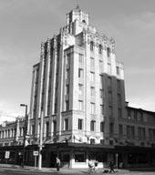 The building incorporated 180 hotel rooms and an ornate ground-floor theater. The original façade was hidden behind an ornamental aluminum covering in 1960. before 21.