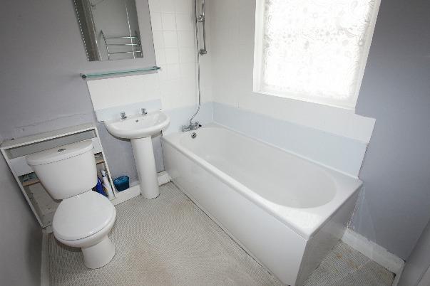 52m A range of work surfaces with tiled splashbacks, plumbing for washing machine, radiator.
