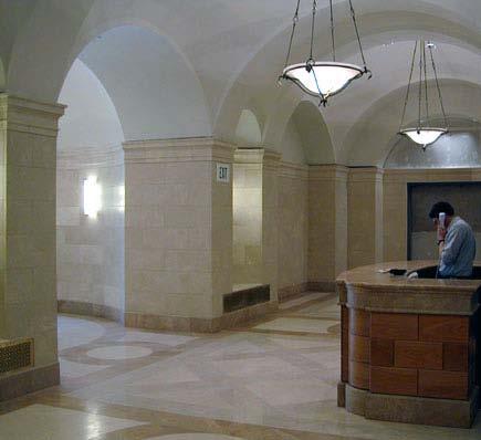 The office lobby features elegant stone floors and walls with