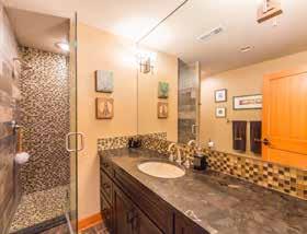 granite vanity. The lower level has a truly elegant powder room with beautiful tile work.