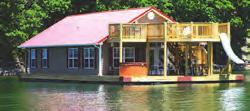 floating houses have large front double decks with an enclosed railing on top, water