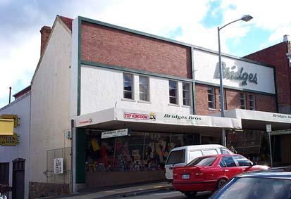 The remaining section has been extensively modified. This building is located on the western side of Elizabeth Street, and is positioned between early to late nineteenth century commercial buildings.