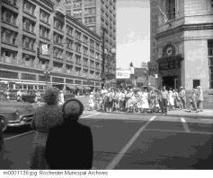 Pedestrians at Clinton Avenue and Main Street. 1954.