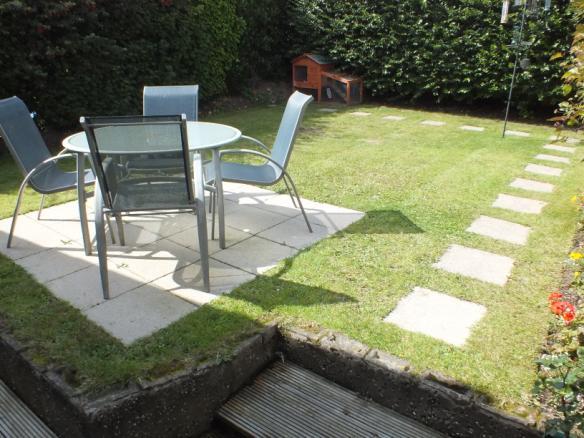 To the rear of the property there is a delightful sunny and private lawned garden with patio area.