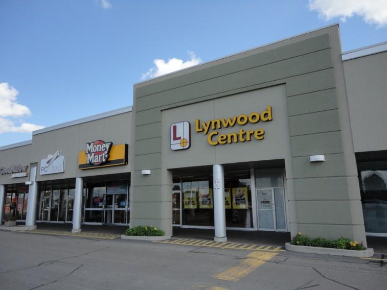 renovated, modern, exterior EIFS cladding; New pylon sign, with tenant names/ logos, on busy