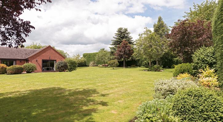 e Gardens and grounds Up and over doors to a 4 car garage with double doors for mower garaging with access to the garden The property is elevated and screened by high evergreen hedging Tarmac