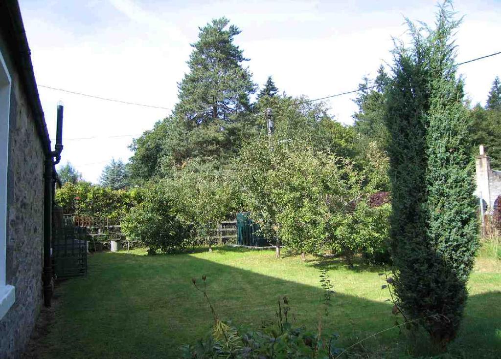Access round to the rear of the property to a lovely enclosed garden with small orchard area, lawn and planting beds.