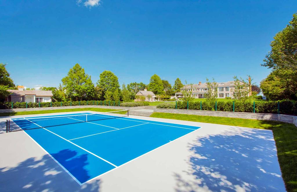 SUNKEN TENNIS COURT A variance allows the sunken tennis court to be pushed further back on the property to maintain the