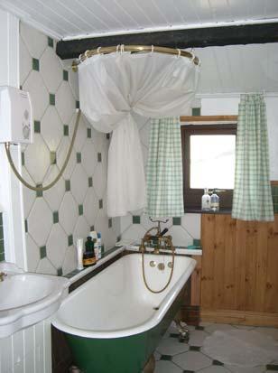 Wainscote style wood paneling to lower walls on two sides with washbasin inset into a wood
