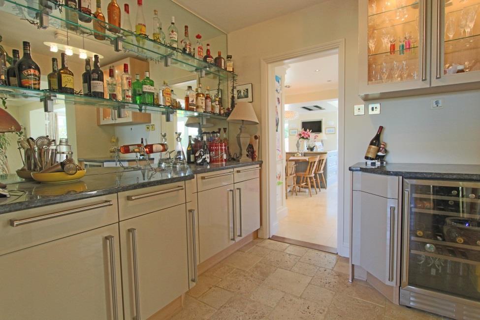 Inner hall 9 x 8 Fitted cream high gloss units with polished granite worktop, Travertine tiled flooring, under counter wine