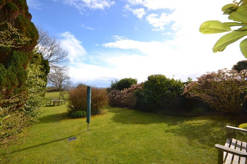 Long south east facing garden with views over countryside to the sea and deep tree and shrub lined boundaries. Sea facing summerhouse, side terrace, workshop.