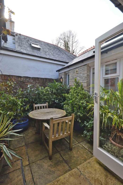 At the bottom of the garden is a sea facing summerhouse and there is also a further large summerhouse to the rear of the property used as a workshop.