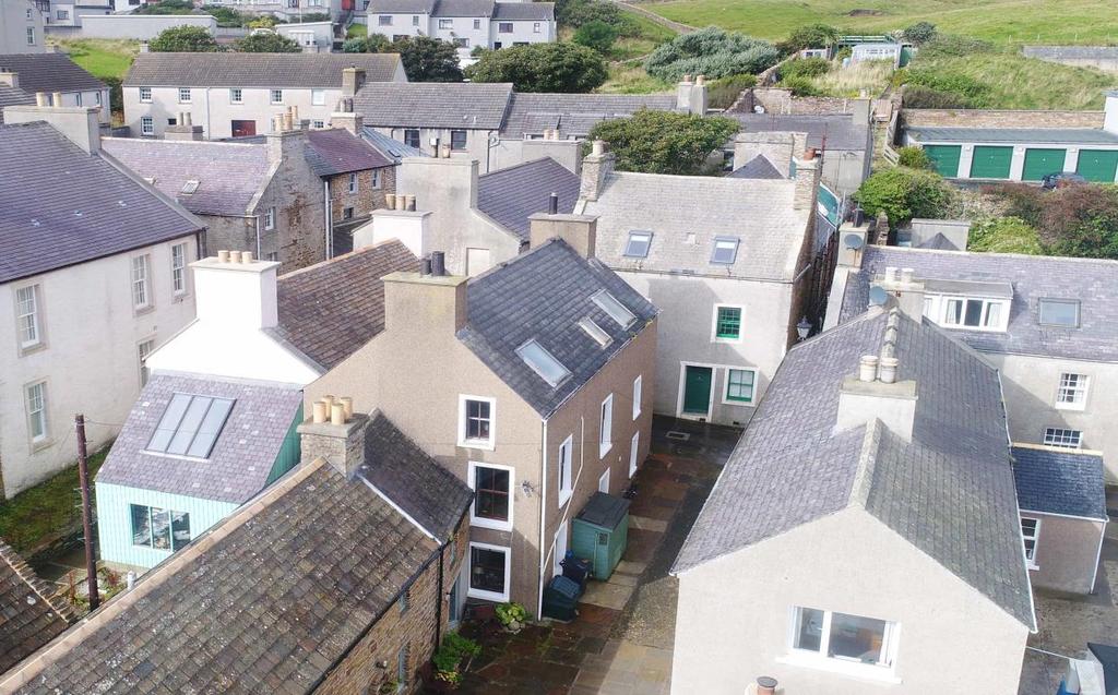 Mainly laid to lawn, it contains wooden garden shed and sheltered decking area with fantastic elevated views of the Stromness