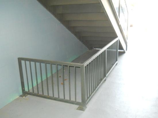 barrier/railing beneath the stairs to provide cane