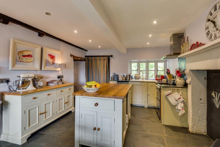 Family Living Kitchen 18' 2" x 12' 0" (5.54m x 3.66m) enjoying an open aspect to the front and rear gardens and with distant views across to Whitbarrow Scar.