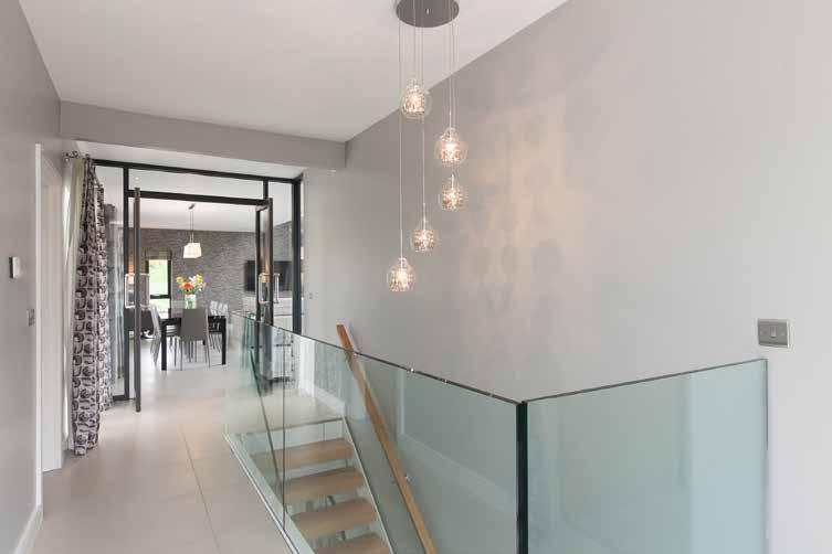 FIRST FLOOR BRIGHT AND SPACIOUS LANDING: Glass balustrade and feature windows to maximise light.