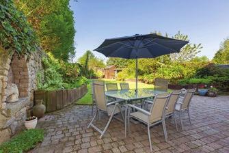 32m (83 1 ) Walled on two sides, this beautiful South West facing garden offers a cobble lock patio area, ideal for al fresco dining and evening entertaining while a lawned area benefits from an
