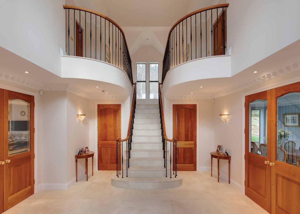 Grand Entrance Hall Having side facing double glazed windows, full height vaulted ceiling, wall mounted light points, decorative coving and honed marble tiled