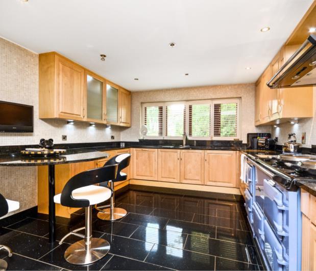 BREAKFAST KITCHEN The kitchen is fully mosaic tiled and has granite worktops with matching granite upstand and granite tiled flooring There is a superb range of luxury modern base and wall units,