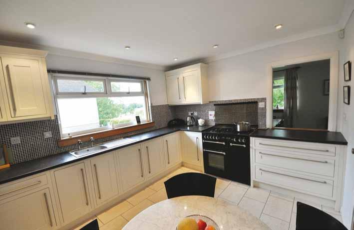 The recently re-fitted dining kitchen displays a range of contemporary units with contrasting worktops.