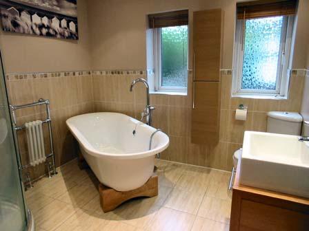 Bathroom: Externally A beautiful newly fitted four piece suite in white comprising of a modern freestanding bath with a chrome stand tap, square basin set on a vanity unit with complementa ry mirror