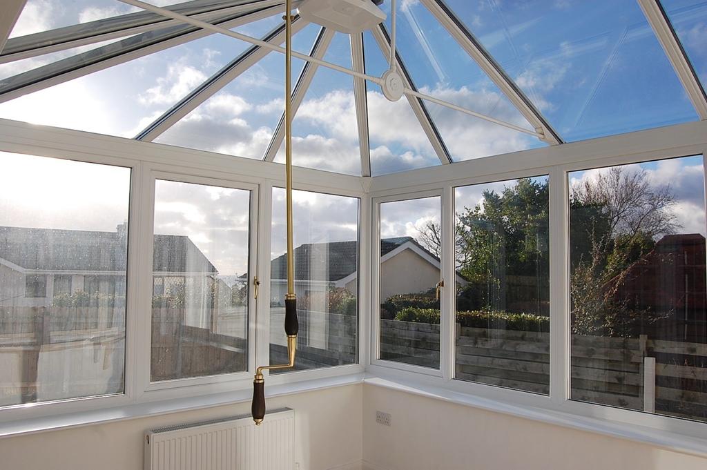 CONSERVATORY 11'6" (3.51 M) x 10'6" (3.20 M) approx. upvc double glazed on half height base walls with opening roof light on attractive brass style fitting. Clear glazed roof. KITCHEN 13'10" (4.