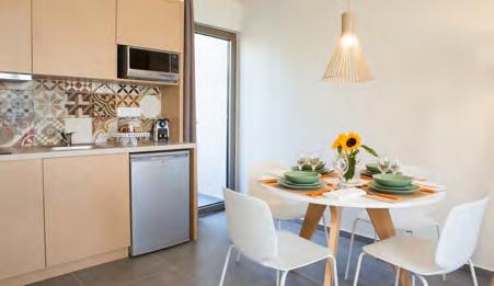 enjoy a meal in the dining area of the apartment.