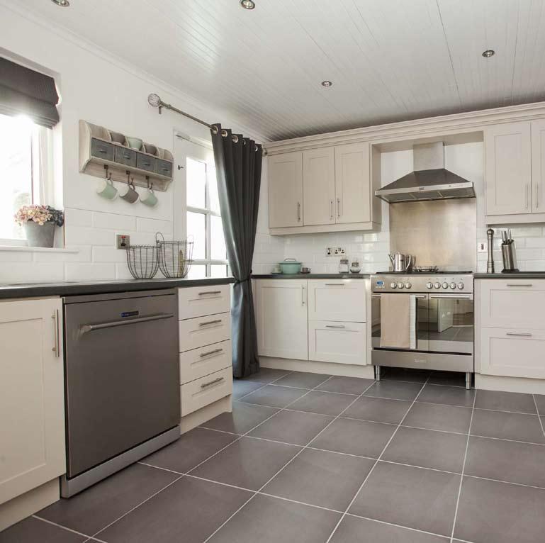 KITCHEN: 13 6 x 12 2 (4.11m x 3.71m) Excellent range of high and low level fitted solid wood units incorporating wine rack, glazed display unit and open shelving. Built in breakfast bar. 1.5 bowl single drainer stainless steel sink unit with mixer taps.