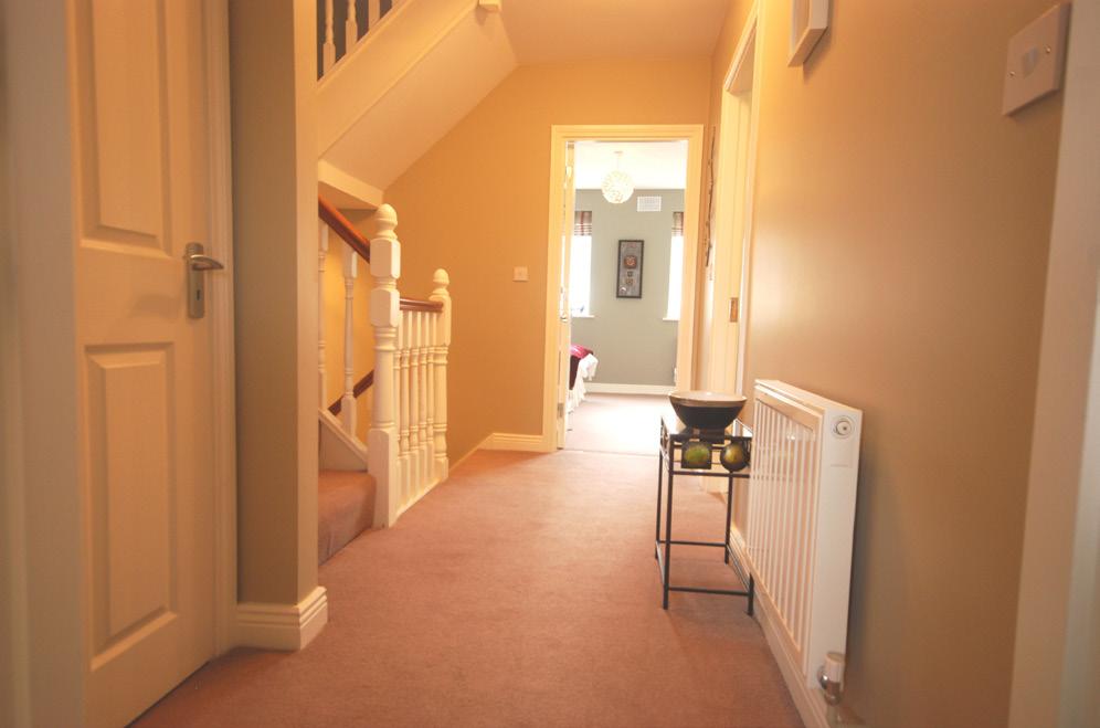 7m) Fine size double room with fitted wardrobes overlooking rear garden. Carpet flooring and door to bathroom.