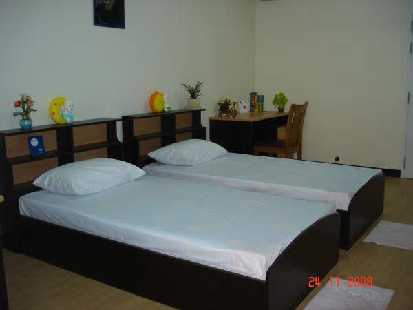 Furnished with beds, desks and closets (blanket and bedsheets are not provided); private shower and toilet (no hot water); balcony (used as a washing area); ceiling fan (no air conditioner); water