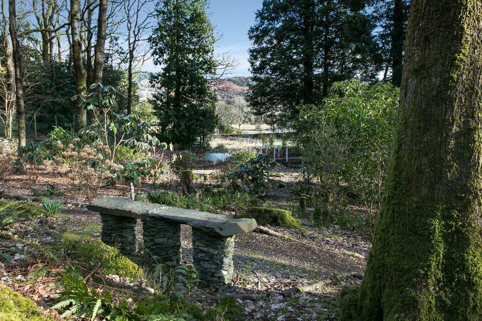 It has been extensively planted with a variety of rhododendrons, camellias, Japanese maples and ferns having barked pathways leading through the planting and hidden seating areas to enjoy.