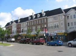Photos of Garrison Woods: Main street in Garrison Woods: buildings that front the sidewalk, with