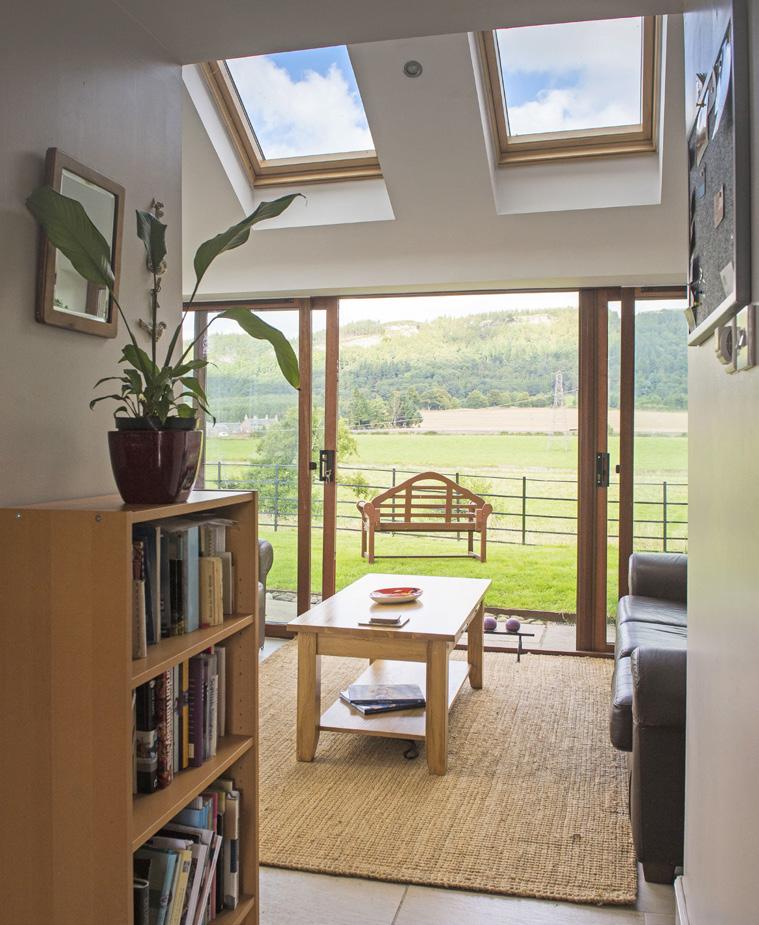 The sun room, located off the modern family dining kitchen, benefits from double glazing and has a beautiful view over open fields, the Earn Valley, and Moncrieffe Hill.