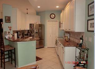The kitchen has granite counter tops, a tile backsplash, new stainless steel refrigerator and dishwasher.