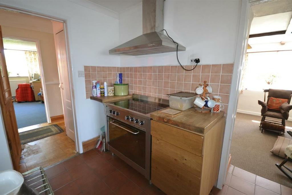 fired Rayburn, tiled floor, wooden base and eye level units with wood work top over and tiled splash-backs, Belfast Sink