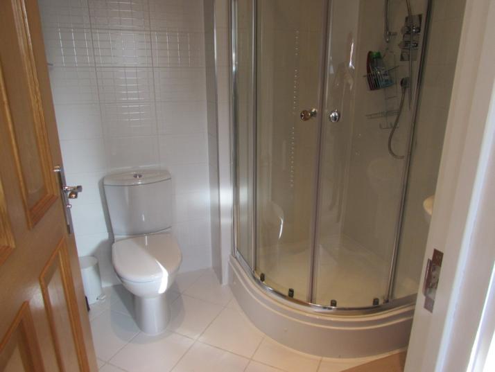 EN SUITE SHOWER ROOM Having a separate shower cubicle, wall mounted wash hand basin, low flush wc, UPVC obscure glazed window and ceramic tiled floor. BEDROOM FOUR (FRONT) 12' 11" x 11' 1" (3.96m x 3.