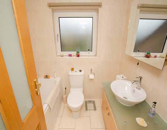 BATHROOM: White suite, panelled bath with mixer taps and