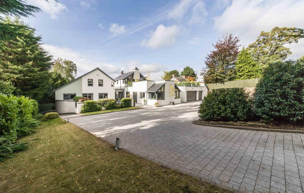 The Property The Hollies is a highly impressive six-bedroom architect designed detached property, set in a generous plot with extensive gardens behind remote-controlled gates for added privacy.