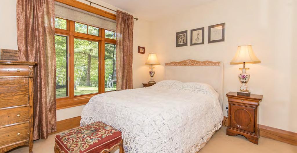 The master suite also boasts a luxurious 5-piece ensuite with Italian etched glass doors, radiant heated floor, Jacuzzi tub with hand-held shower, walk-in separate glass shower with tumble stone and