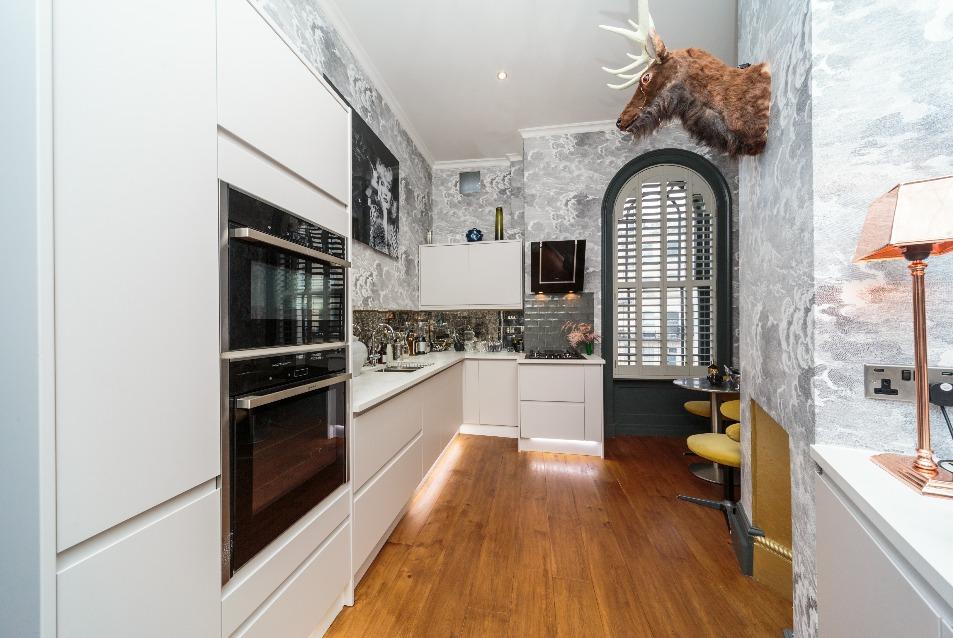 The Entrance and Dining Room - Even the hallway sets the bar high, decorated in darkly glittering Cole and Son wall paper and directly ahead, double doors invite you into the heart of this home, a
