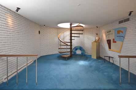 Two changing rooms, both with showers, are conveniently accessed by outdoor stairs to the pool.