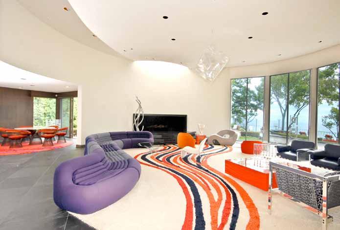 Spectacular Living Room The living circular living room enjoys spectacular views of terraces, pool, lawn, flowers and Lake