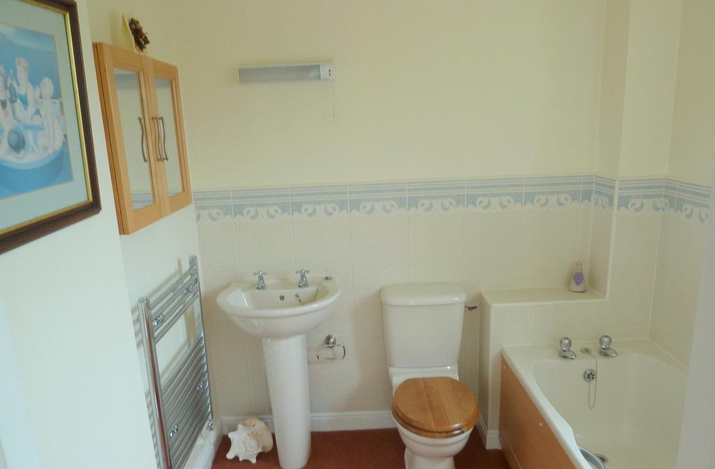 DOWNSTAIRS BATHROOM Bathroom 6'11" (2.11 m) X 6'3" (1.92 m) 3-piece bathroom suite: Twin grip panel bath, low flush W/C, pedestal washbasin.