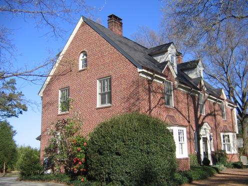 The east elevation features a two-story wing that once may have been a porch or sunroom. The second-story room overhangs the lower room on all three sides.